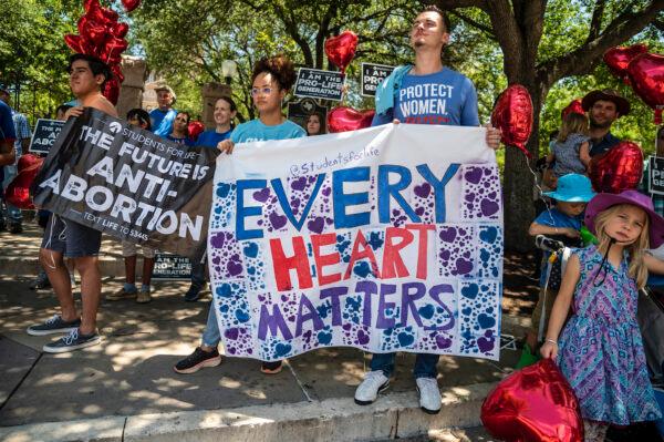 Pro-life protesters stand near the gate of the Texas state capitol on May 29, 2021. (Sergio Flores/Getty Images)