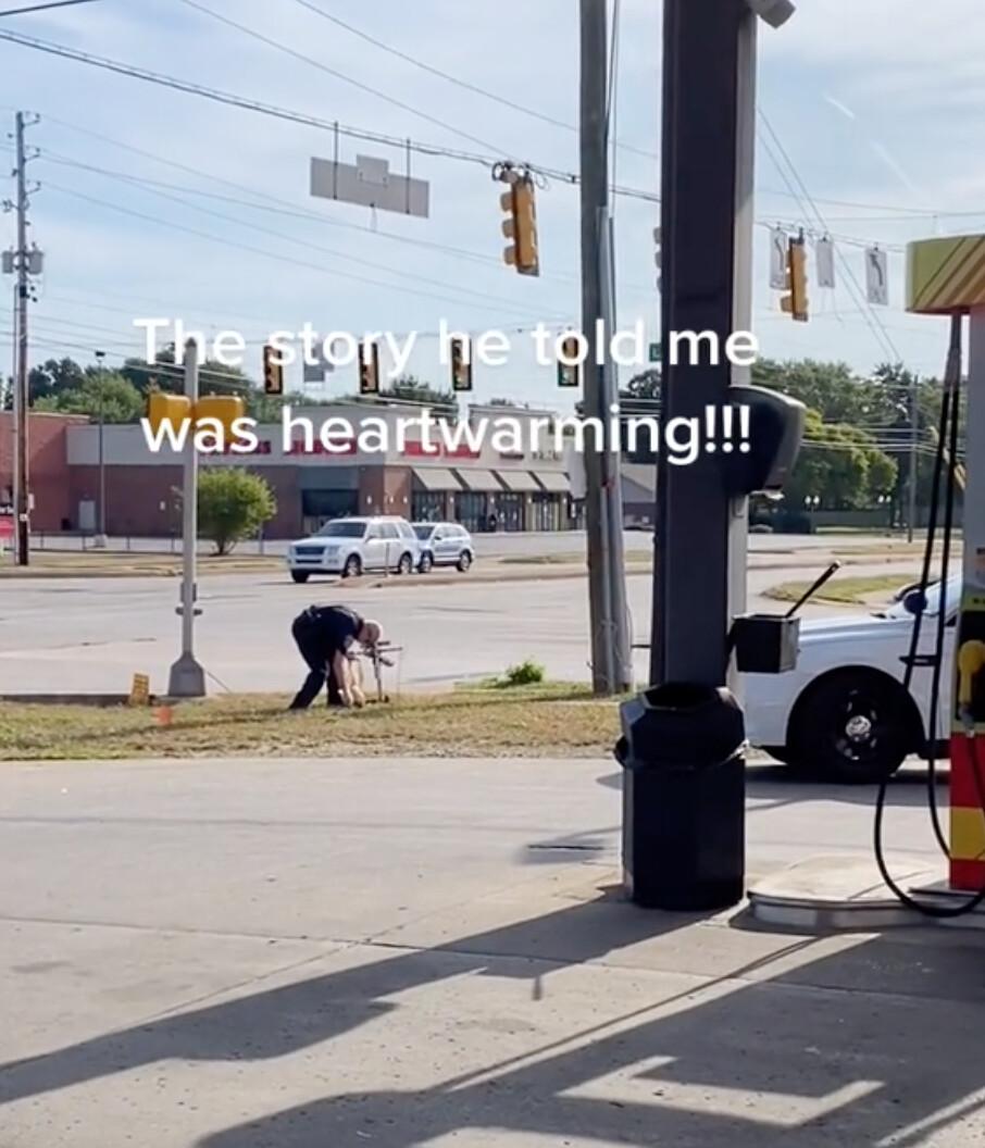 IMPD's veteran officer Jeff Stagg picking up trash from the memorial site of a crash victim at the intersection of Rockville Road and Lyndhurst Drive, Indianapolis. (Courtesy of Kaleb Hall)