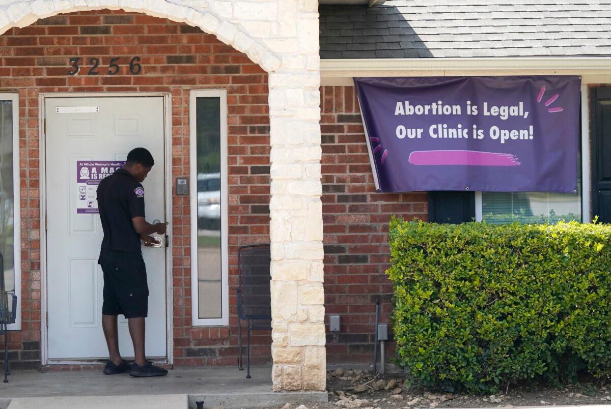 A security guard opens the door to the Whole Women's Health Clinic in Fort Worth, Texas, on Sept. 1, 2021. (LM Otero/AP Photo)