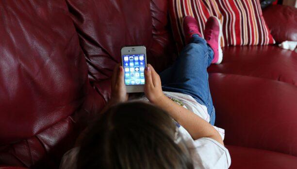 A child uses an Apple smartphone in this undated file image (PA)