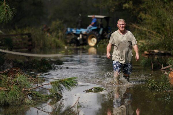 Russell Threeton, a strawberry farmer, walks through floodwater after Hurricane Ida in Springfield, La., on Sept. 1, 2021. (Sean Rayford/Getty Images)