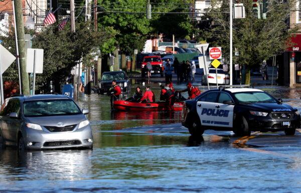 First responders pull local residents in a boat as they perform rescues of people trapped by floodwaters after the remnants of Tropical Storm Ida brought drenching rain, flash floods and tornadoes to parts of the northeast in Mamaroneck, New York, Sept. 2, 2021. (Mike Segar/Reuters)