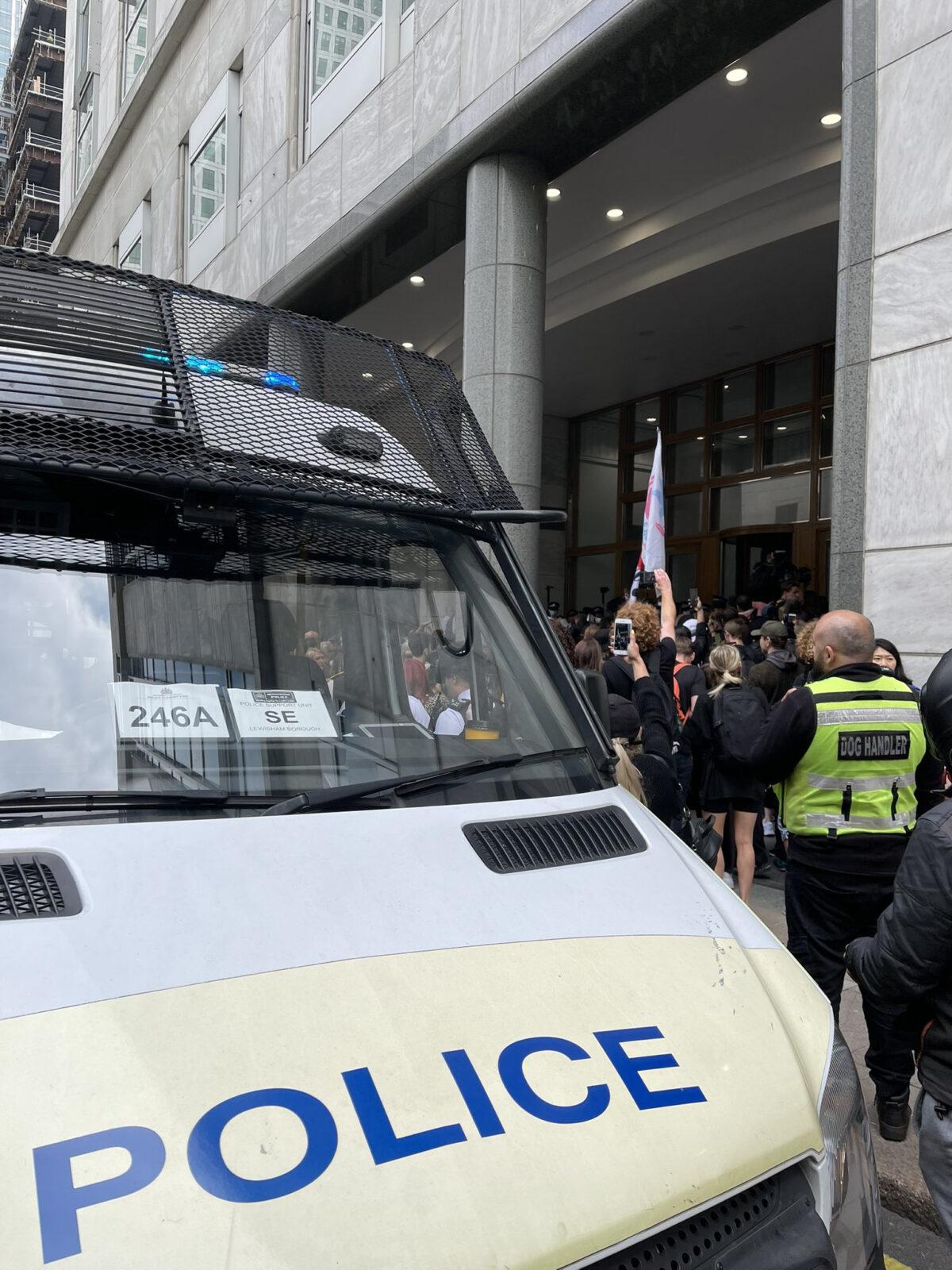A group of protesters try to get past police and into the headquarters of the MHRA in central London on Sept. 3, 2021. (Andrew Wood/Twitter/PA