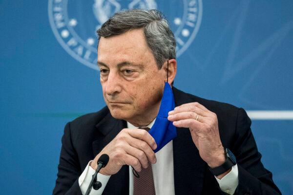 Italian Prime Minister Mario Draghi removes his face mask during a press conference in Rome, on July 22, 2021. (Roberto Mondalo/POOL/AFP via Getty Images)