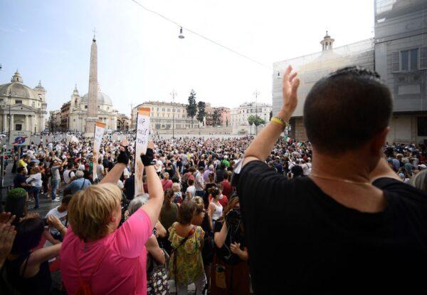 Protesters take part in a demonstration in Piazza del Popolo in Rome against the introduction of a mandatory 'green pass' for indoor dining and entertainment area, on July 24, 2021. (Filippo Monteforte/AFP via Getty Images)
