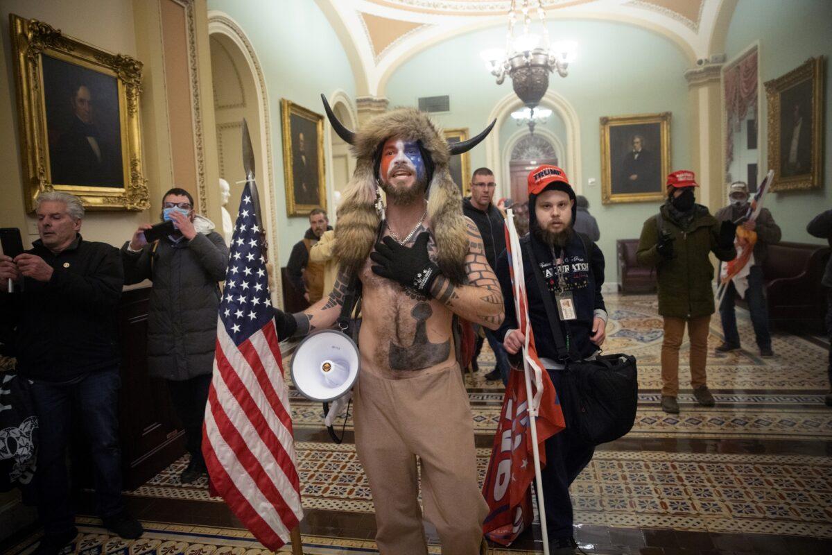 Jacob Chansley (C) and Nicholas Rodean, wearing a red hat, inside the U.S. Capitol in Washington on Jan. 6, 2021. (Win McNamee/Getty Images)