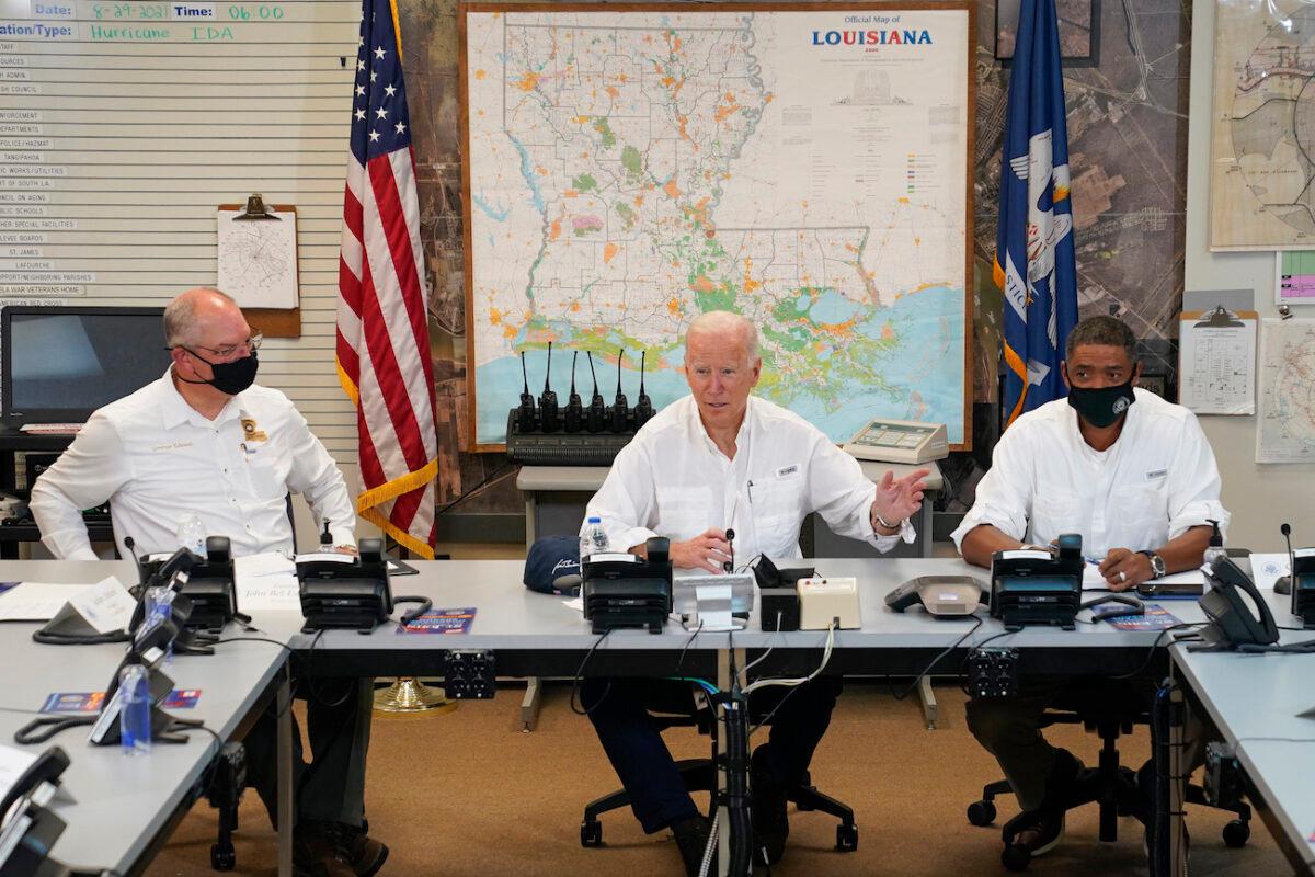 President Joe Biden participates in a briefing about the response to damage caused by Hurricane Ida, as Louisiana Gov. John Bel Edwards (L) and White House senior adviser Cedric Richmond listen, at the St. John Parish Emergency Operations Center, in LaPlace, La., on Sept. 3, 2021. (Evan Vucci/AP Photo)