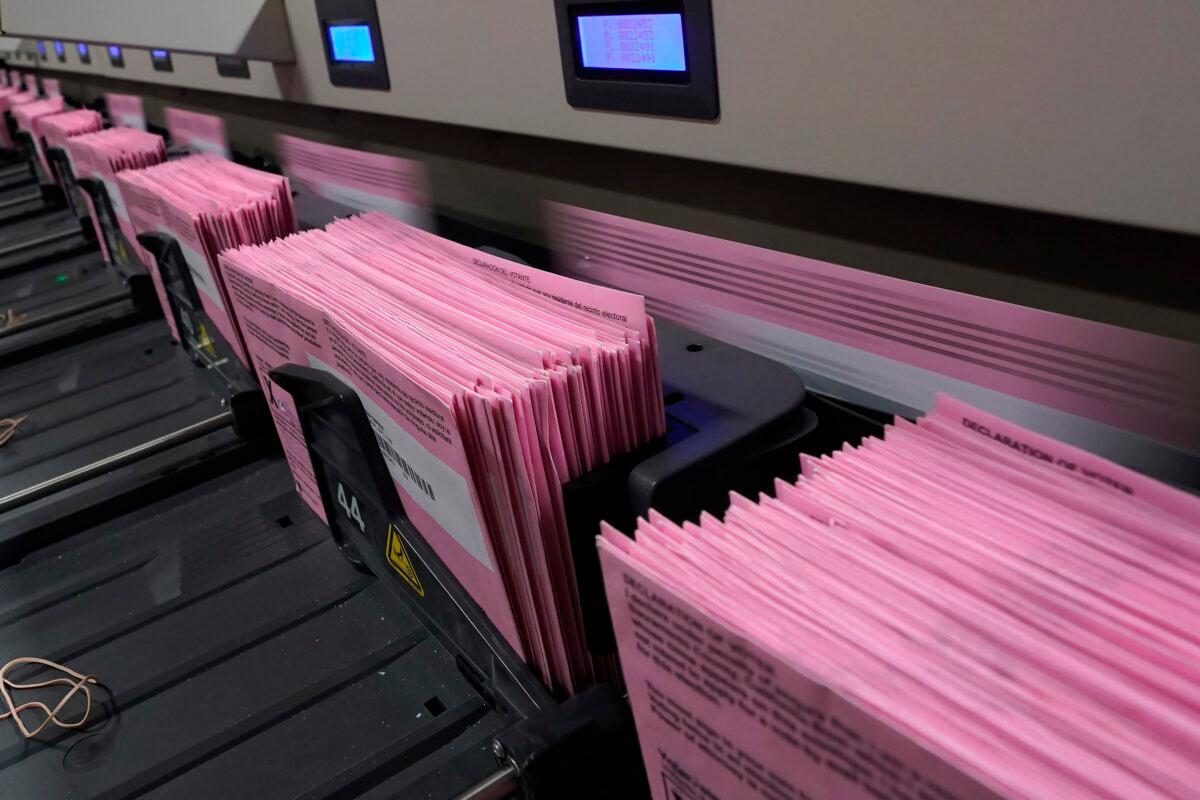 Mail in ballots run through a sorting machine at the Sacramento County Registrar of Voters office in Sacramento, Calif., on Aug. 30, 2021. (Rich Pedroncelli/AP Photo)