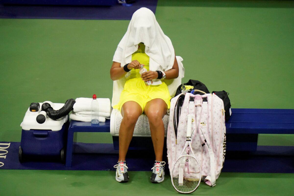 Naomi Osaka, of Japan, covers her head between games against Leylah Fernandez, of Canada, at the third round of the U.S. Open tennis championships, N.Y., on Sept. 3, 2021. (Frank Franklin II/AP Photo)