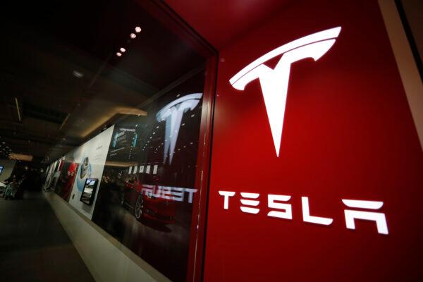 A file photo of a sign bearing the company logo outside a Tesla store in Cherry Creek Mall in Denver. (David Zalubowski/AP Photo)