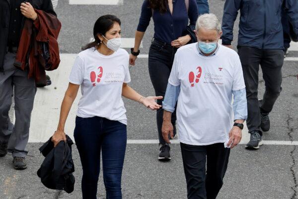 Vina Nadjibulla, wife of Michael Kovrig, speaks with Canada's Minister of Foreign Affairs Marc Garneau during a march to mark 1,000 days since Kovrig and Michael Spavor were arrested in China, during a protest in Ottawa on Sept. 5, 2021. (Reuters/Blair Gable)