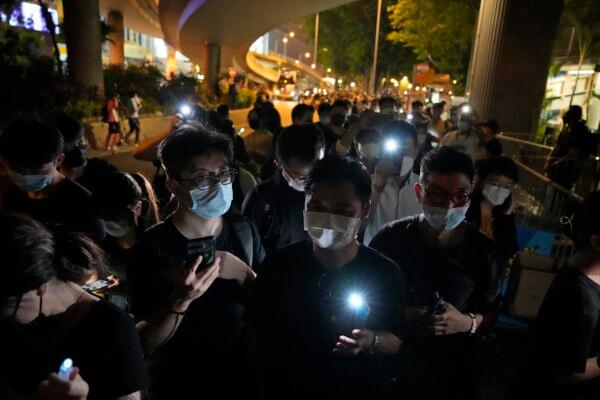 People hold LED candles to mark the anniversary of the military suppression of a pro-democracy student movement in Beijing, outside Victoria Park in Hong Kong, on June 4, 2021. (Kin Cheung/AP Photo)