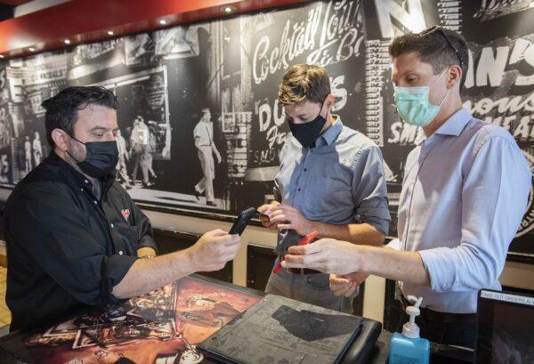 A customer’s COVID-19 QR code is scanned at a restaurant in Montreal on Sept. 1, 2021. (The Canadian Press/Graham Hughes)