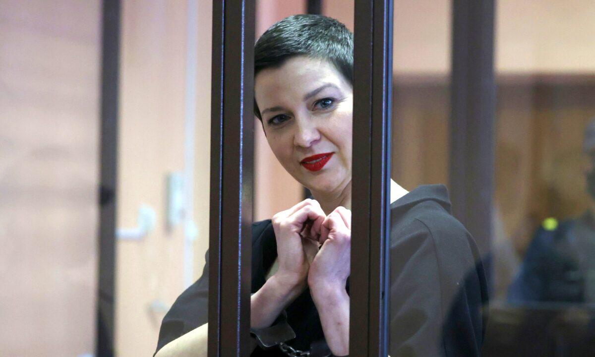 Belarusian opposition politician Maria Kolesnikova, charged with extremism and trying to seize power illegally, gestures inside a defendants' cage as she attends a court hearing in Minsk, Belarus, on Sept. 6, 2021. (Ramil Nasibulin/BelTA/Handout via Reuters)