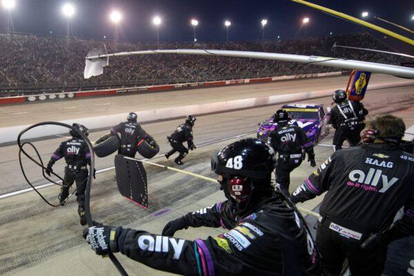 Crew members work the pit as Alex Bowman comes in during a NASCAR Cup Series auto race in Darlington, S.C., on Sept. 5, 2021. (John Amis/AP Photo)