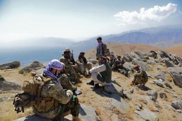 Afghan resistance movement and anti-Taliban forces take rest as they patrol on a hilltop in Darband area in Anaba district, Panjshir province on Sept. 1, 2021. (Ahmad Sahel Arman/AFP via Getty Images)