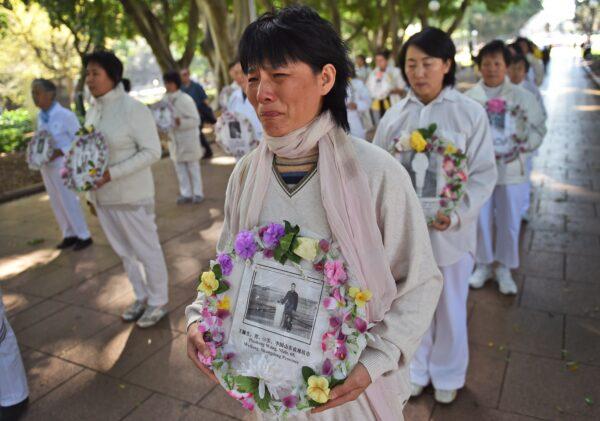 Falun Gong practitioners march to show their support for the global lawsuit action against China's former leader Jiang Zemin in Sydney, Australia, on Sept. 4, 2015. (William West/AFP via Getty Images)