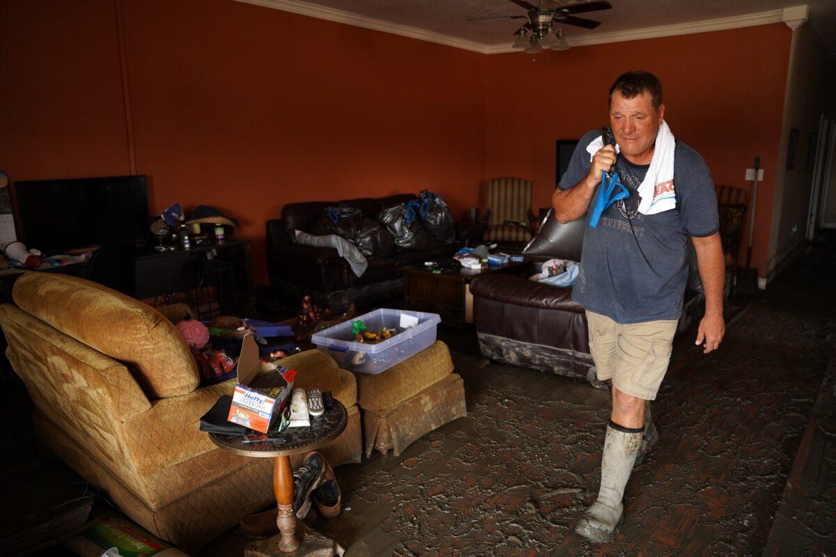 Shane Holder works to clean out his storm-damaged residence where he and his wife ran an RV park on the beach, in Grand Isle, La., on Sept. 3, 2021. (Sean Rayford/Getty Images)