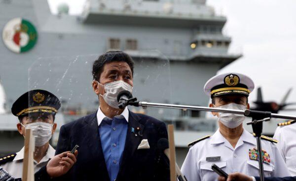 Japan's Defense Minister Nobuo Kishi (C) speaks to the members of the media after he inspected the British Royal Navy's HMS Queen Elizabeth aircraft carrier back at the U.S. naval base in Yokosuka, Kanagawa Prefecture, Japan, on Sept. 6, 2021. (Kiyoshi Ota/Pool Photo via AP)