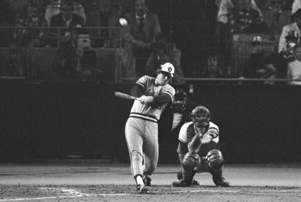 Milwaukee Brewers' Ted Simmons follows through on his home run swing as St. Louis Cardinals catcher Darrell Porter and home plate umpire Lee Weyer watch in the fourth inning of a World Series game in St. Louis, Mo., on Oct. 12, 1982. (AP Photo)
