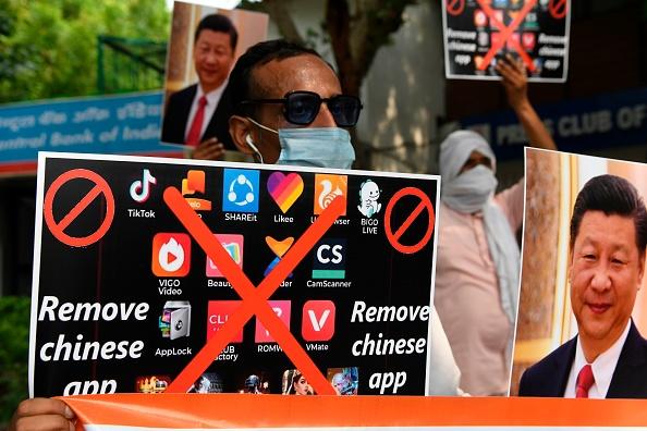 Members of the Working Journalists of India (WJI) hold placards urging citizens to remove Chinese apps and to stop using Chinese products during a demonstration against the Chinese newspaper Global Times in New Delhi on June 30, 2020. (PRAKASH SINGH/AFP via Getty Images)