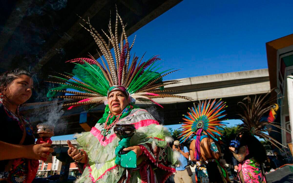 Traditional Aztec dancers prepare to perform at Chicano Park in San Diego on Feb. 3, 2018. (Sandy Huffaker/AFP via Getty Images)