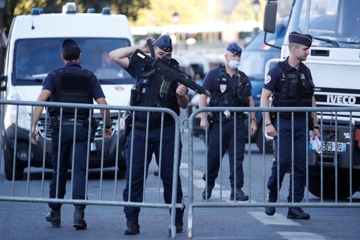 French Police forces secure near the Paris courthouse on the Ile de la Cite France before the start of the trial of the Paris' November 2015 attacks, in Paris, France, on Sept. 8, 2021. (Christian Hartmann/Reuters)