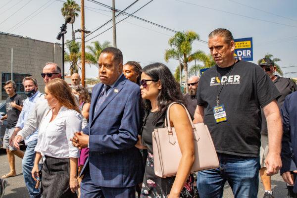 Larry Elder walks with staff and residents of Venice Beach, Calif., through streets with high populations of homeless individuals on Sept. 8, 2021. (John Fredricks/The Epoch Times)