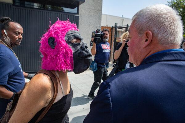 A woman throwing objects at Larry Elder later assulted a member of Elder's security team in Venice Beach, Calif., on Sept. 8, 2021. (John Fredricks/The Epoch Times)