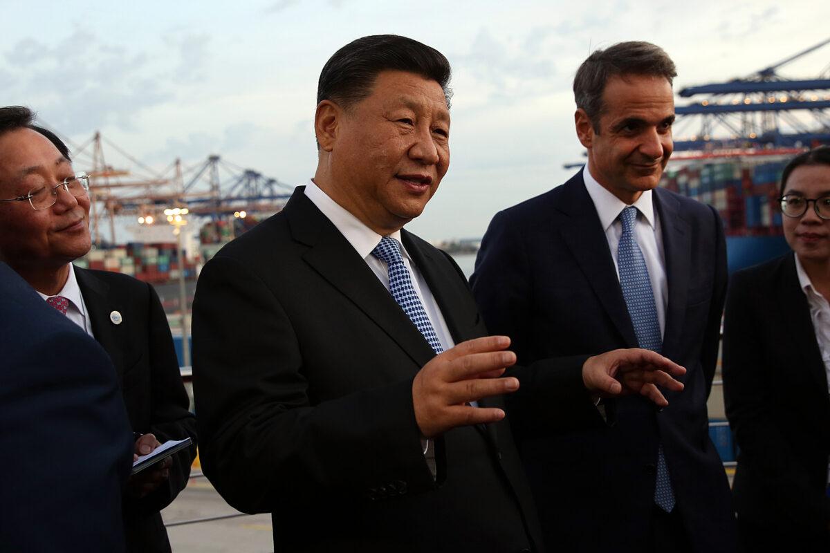 Chinese leader Xi Jinping (L) and Greek Prime Minister Kyriakos Mitsotakis visit the cargo terminal of Chinese company Cosco in the Port of Piraeus, Greece, on Nov. 11, 2019. (Orestis Panagiotou/AFP via Getty Images)