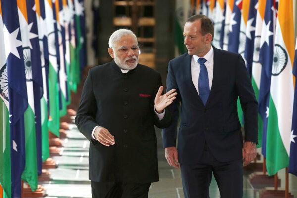 (L-R) India's Prime Minister Narendra Modi and then Australian Prime Minister Tony Abbott walk together as they leave the House of Representatives at Parliament House in Canberra, Australia, on Nov. 18, 2014. (Rick Rycroft- Pool/Getty Images)