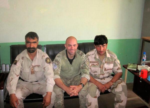 Ryan Brummond, U.S. Special Forces Officer (C) is seated next to Mohammad Khalid Wardak (R) in Afghanistan. (Ryan Brummond via AP)