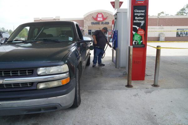 Rob Fontenot pumps gas after Hurricane Ida at Big Boss Travel Plaza in Tickfaw, La., on Sept. 3, 2021. (Jackson Elliott/The Epoch Times)