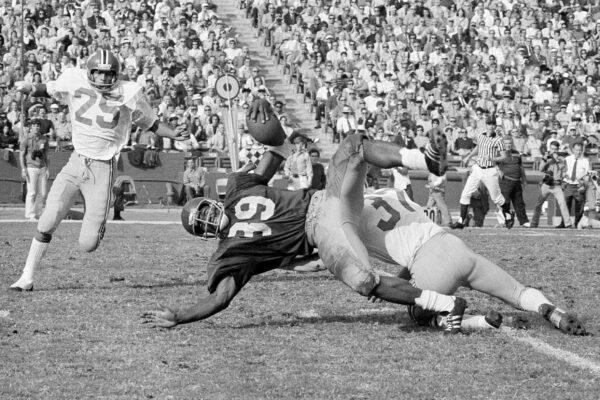 Southern California fullback Sam Cunningham (39) is brought down by Washington State's Eric Johnson after picking up 16 yards at the Los Angeles Coliseum in Los Angeles, Calif., on Nov. 6, 1971. (David F. Smith/AP Photo)