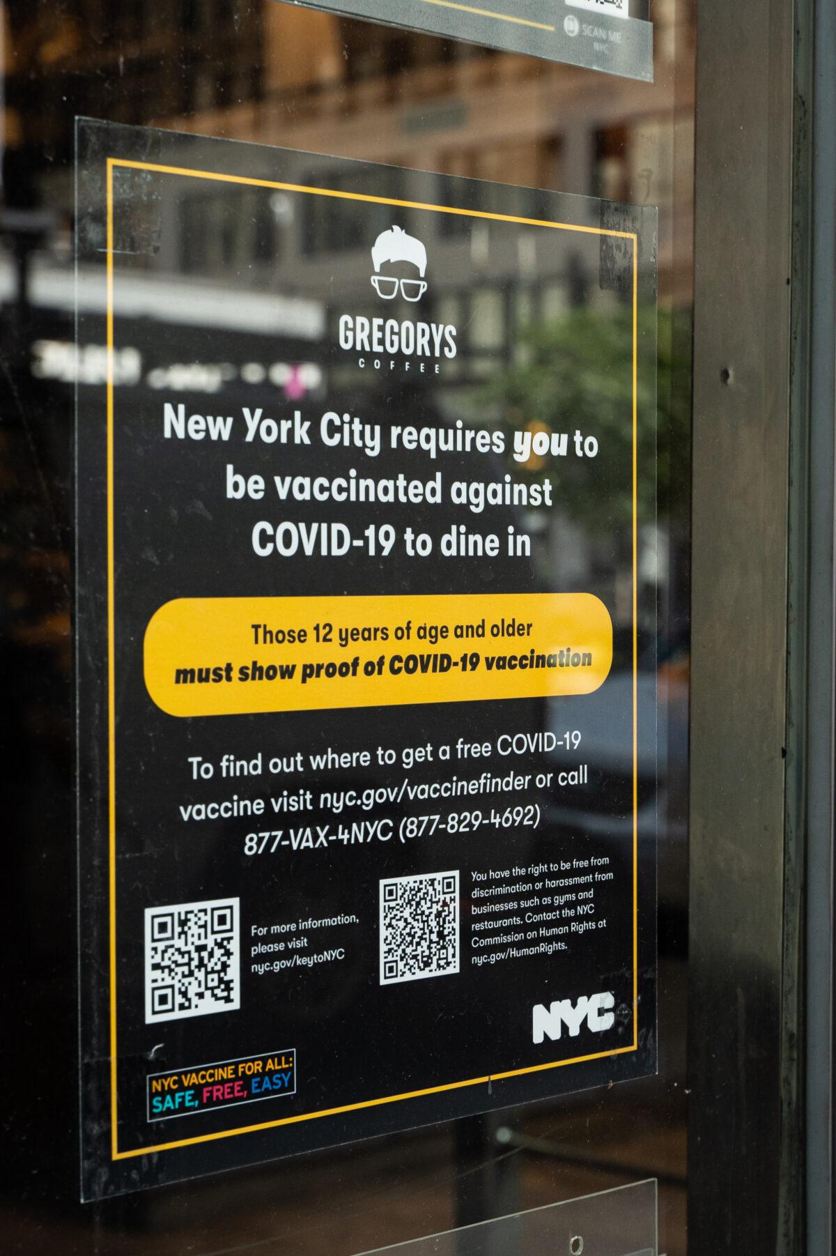 Information about COVID-19 vaccine verification on a restaurant storefront in New York City on Sept. 7, 2021. (Chung I Ho/The Epoch Times)
