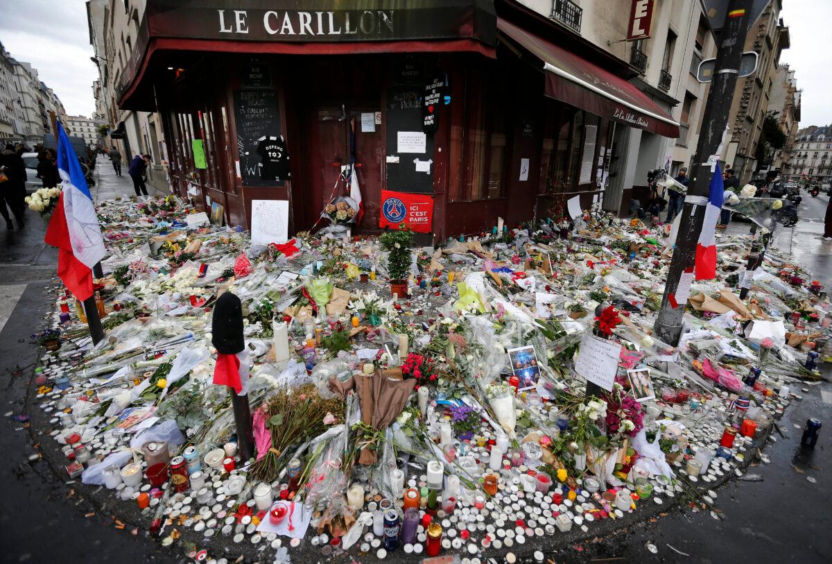 Flowers and candle tributes are placed at the Restaurant Le Carillon following terrorist attacks in Paris, on Nov. 13, 2015. (Frank Augstein/AP/File)