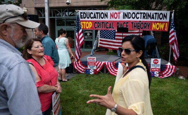 People talk before the start of a rally against critical race theory being taught in schools at the Loudoun County Government Center in Leesburg, Va., on June 12, 2021. (Andrew Caballero-Reynolds/AFP via Getty Images)