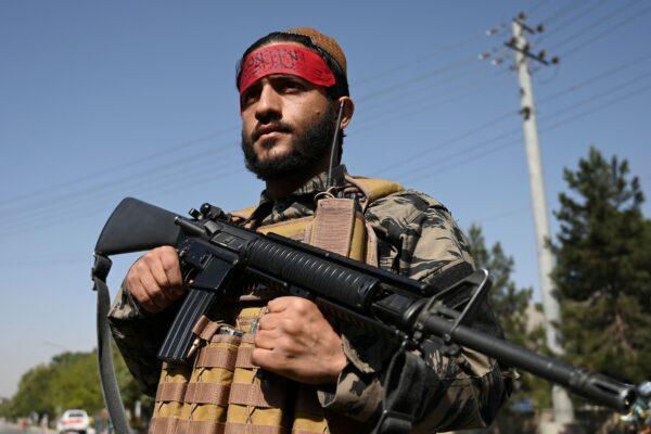A Taliban fighter stands guard along a road in Kabul on Sept. 9, 2021. (Wakil Kohsar/AFP via Getty Images)
