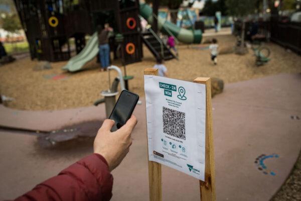 A parent uses the QR code check-in at a playground in Brunswick in Melbourne, Australia, on Sept. 03, 2021. (Darrian Traynor/Getty Images)