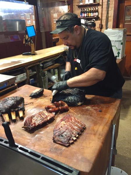 Manuel Garcia carves smoked meats to order at Black's BBQ. (Eric Lucas)