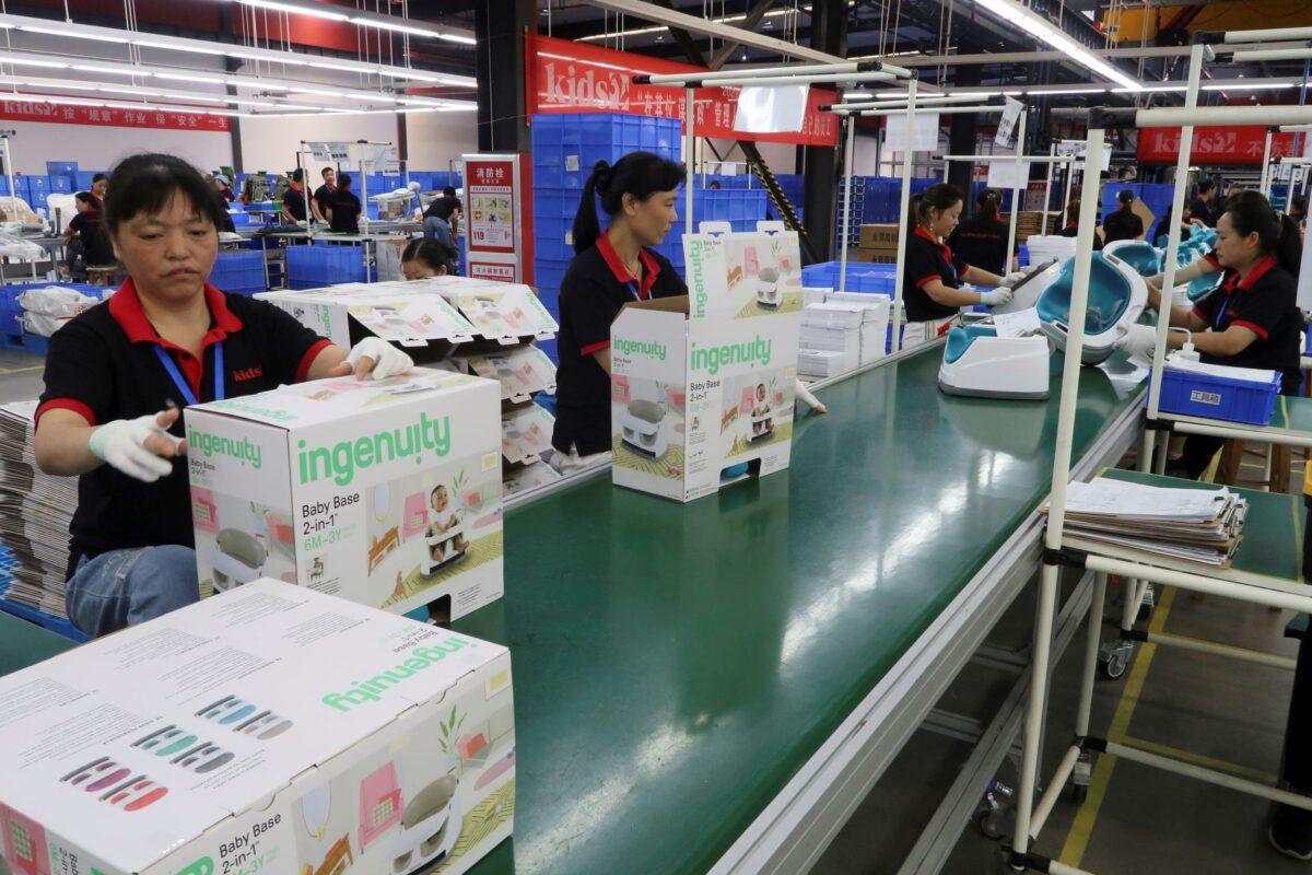 Employees work on the production line of American infant product and toy manufacturer Kids II Inc. at a factory in Jiujiang, Jiangxi Province, China on June 22, 2021. (Gabriel Crossley/Reuters)
