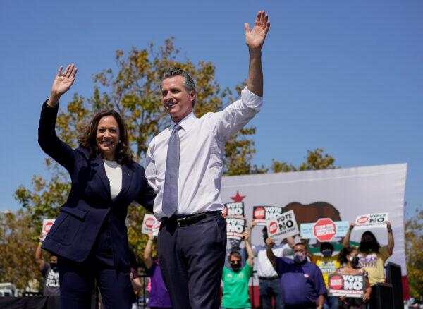 Vice President Kamala Harris stands on stage with California Gov. Gavin Newsom at the conclusion of an event at the IBEW-NECA Joint Apprenticeship Training Center in San Leandro, Calif., Sept. 8, 2021. (AP Photo/Carolyn Kaster)