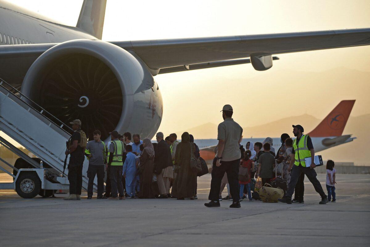 Passengers prepare to board a Qatar Airways aircraft at the airport in Kabul, Afghanistan, on Sept. 9, 2021. (Wakil Kohsar/AFP via Getty Images)