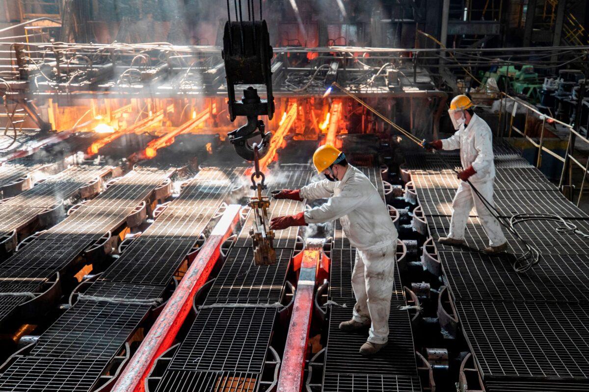 Workers make iron bars in a steel factory in Lianyungang, in China's eastern Jiangsu Province on Feb. 12, 2021. (AFP via Getty Images)