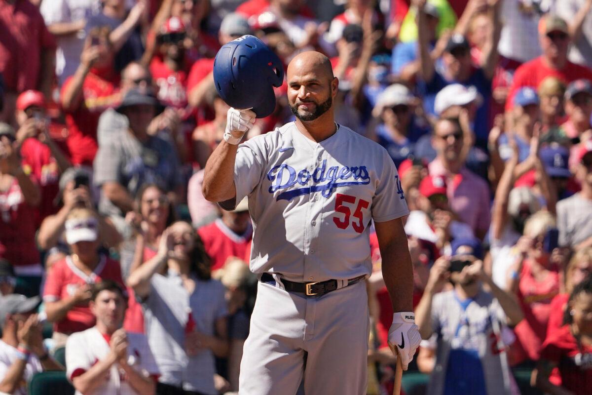 Los Angeles Dodgers' Albert Pujols tips his cap to cheering fans as he steps up to bat during the seventh inning of a baseball game against the St. Louis Cardinals in St. Louis on Sept. 9, 2021. (AP Photo/Jeff Roberson)