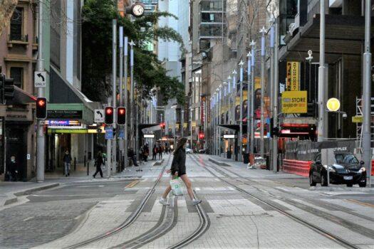 This picture, taken on Aug. 27, 2021, shows a girl wearing a face mask walking through the empty streets of the central business district in Sydney, Australia, during the lockdown. (Saeed Khan/AFP via Getty Images)