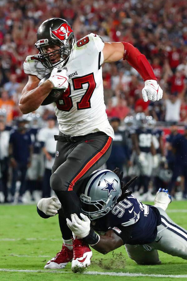 Tampa Bay Buccaneers tight end Rob Gronkowski (87) beats Dallas Cowboys defensive end DeMarcus Lawrence (90) to the endzone to score on an 11-yard touchdown reception during the second half of an NFL football game in Tampa, Fla., on Sept. 9, 2021. (Mark LoMoglio/AP Photo)