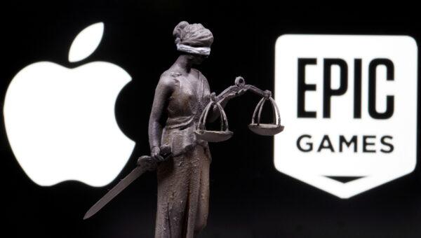 3D printed Lady Justice figure is seen in front of displayed Apple and Epic Games logos in this illustration photo taken on Feb. 17, 2021. (Dado Ruvic/Illustration/Reuters)