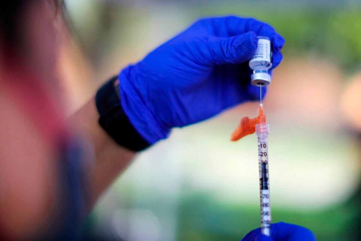 A nurse prepares a Pfizer BioNTech COVID-19 vaccination in Los Angeles, on Aug. 23, 2021. (Lucy Nicholson/Reuters)