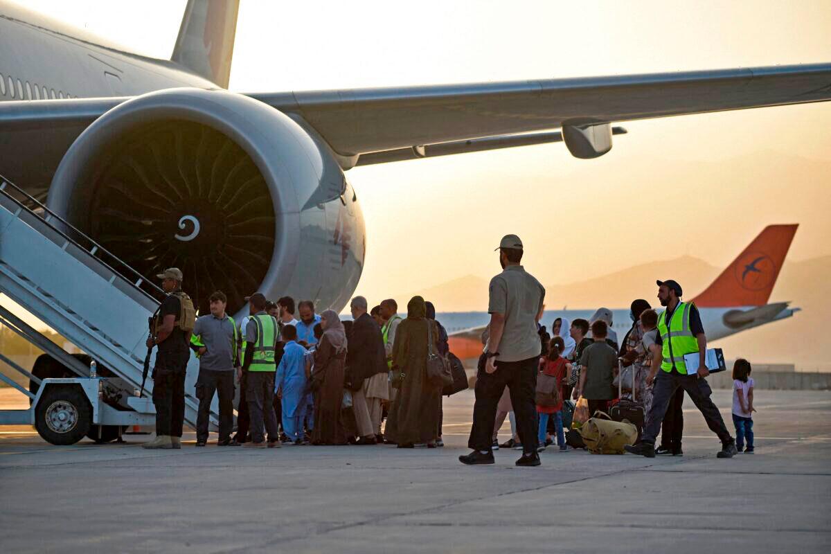Passengers prepare to board a Qatar Airways aircraft at the airport in Kabul, Afghanistan on Sept. 9, 2021. (Wakil Kohsar/AFP via Getty Images)